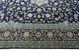 Corner detail of 2000s Kashan rug showing border pattern and Wool pile