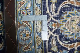 Backside of handmade 2000s Kashan rug showing knot structure and weave density