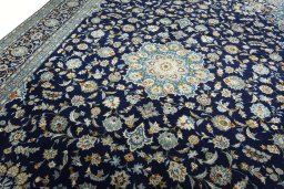 Backside of handmade 2000s Kashan rug showing knot structure and weave density