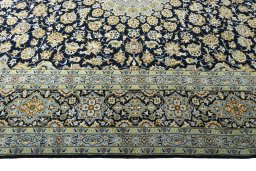 Corner detail of 2000s Kashan rug showing border pattern and Wool pile