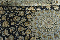 Close-up detail of 2000s Kashan rug from Iran / Persia showing Wool weave
