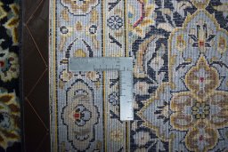 Backside of handmade 2000s Kashan rug showing knot structure and weave density