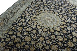 Backside of handmade 2000s Kashan rug showing knot structure and weave density