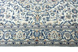 Corner detail of 2000s Kashan rug showing border pattern and Wool pile