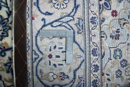 Backside of handmade 2000s Kashan rug showing knot structure and weave density