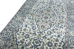 Backside of handmade 2000s Kashan rug showing knot structure and weave density
