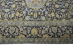 Corner detail of 2000s Kashan rug showing border pattern and Wool pile
