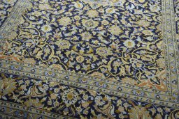 Close-up detail of 2000s Kashan rug from Iran / Persia showing Wool weave