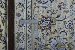 Backside of handmade 2000s Kashan rug showing knot structure and weave density