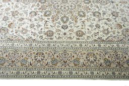 Corner detail of 2000s Kashan rug showing border pattern and Wool pile