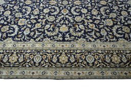 Corner detail of 2000s Kashan rug showing border pattern and Wool pile