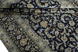 Close-up detail of 2000s Kashan rug from Iran / Persia showing Wool weave