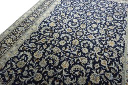 Backside of handmade 2000s Kashan rug showing knot structure and weave density