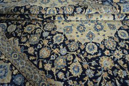 Close-up detail of 2000s Kashan rug from Iran / Persia showing Wool weave