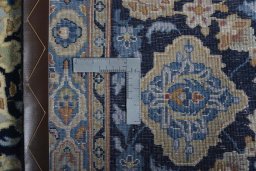 Backside of handmade 2000s Kashan rug showing knot structure and weave density