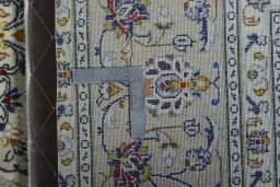 Backside of handmade 2000s Kashan rug showing knot structure and weave density