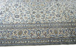 Corner detail of 2000s Kashan rug showing border pattern and Wool pile