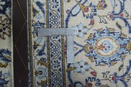 Backside of handmade 2000s Kashan rug showing knot structure and weave density