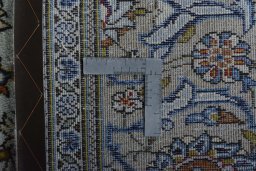 Backside of handmade 2000s Kashan rug showing knot structure and weave density