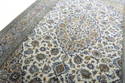 Backside of handmade 2000s Kashan rug showing knot structure and weave density