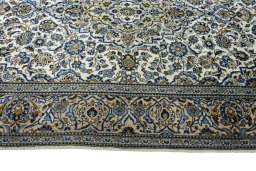 Corner detail of 2000s Kashan rug showing border pattern and Wool pile