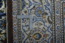 Backside of handmade 2000s Kashan rug showing knot structure and weave density