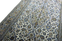 Backside of handmade 2000s Kashan rug showing knot structure and weave density