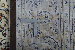 Backside of handmade New Kashan rug showing knot structure and weave density
