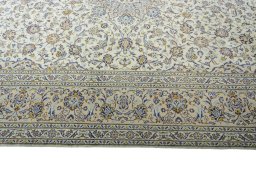 Corner detail of 2000s Kashan rug showing border pattern and Wool pile
