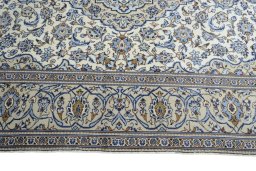 Corner detail of 2000s Kashan rug showing border pattern and Wool pile