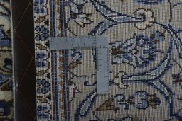 Backside of handmade 2000s Kashan rug showing knot structure and weave density