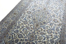 Backside of handmade 2000s Kashan rug showing knot structure and weave density