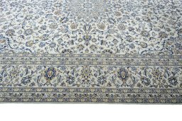 Corner detail of 2000s Kashan rug showing border pattern and Wool pile