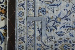 Backside of handmade 2000s Kashan rug showing knot structure and weave density