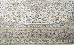 Corner detail of 2000s Kashan rug showing border pattern and Wool pile