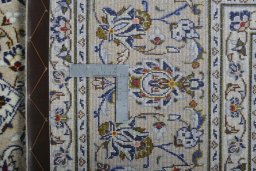 Backside of handmade 2000s Kashan rug showing knot structure and weave density