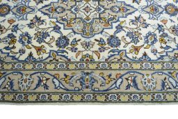 Corner detail of 2000s Kashan rug showing border pattern and Wool pile