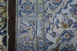 Backside of handmade 2000s Kashan rug showing knot structure and weave density