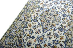 Backside of handmade 2000s Kashan rug showing knot structure and weave density