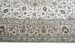 Corner detail of 2000s Kashan rug showing border pattern and Wool pile