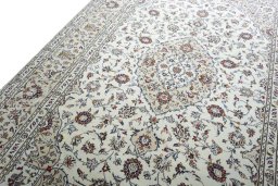 Backside of handmade 2000s Kashan rug showing knot structure and weave density