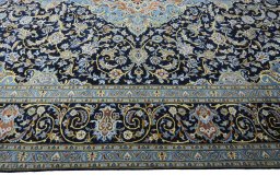 Corner detail of 2000s Kashan rug showing border pattern and Wool pile