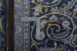 Backside of handmade 2000s Kashan rug showing knot structure and weave density