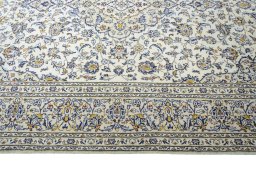 Corner detail of 2000s Kashan rug showing border pattern and Wool pile