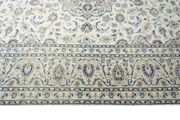 Corner detail of 2000s Kashan rug showing border pattern and Wool pile