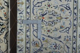 Backside of handmade 2000s Kashan rug showing knot structure and weave density