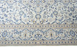 Corner detail of 2000s Kashan rug showing border pattern and Wool pile