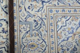 Backside of handmade 2000s Kashan rug showing knot structure and weave density