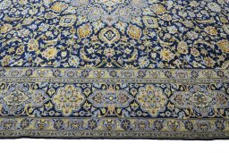 Corner detail of 2000s Kashan rug showing border pattern and Wool pile