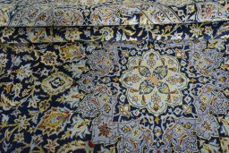 Close-up detail of 2000s Kashan rug from Iran / Persia showing Wool weave